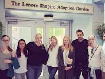 Group posing for a picture at the entrance of Lenore Shapiro Adoption Center. 