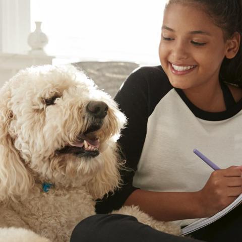 A young woman and a large white dog